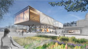Architekturvisualisierung des geplanten Pina Bausch Zentrums in Wuppertal. Ein langgestreckter, teilweise auf Stützen stehender Neubau verbindet sich mit bestehenden Gebäuden. Im Vordergrund liegt eine bepflanzte Fläche mit Wildblumen, auf dem Platz bewegen sich zahlreiche Menschen oder halten sich dort auf. Die offene Gestaltung mit Grünflächen und öffentlich zugänglichen Bereichen verweist auf das Zentrum als Ort für Kunst, Begegnung und nachhaltige Stadtentwicklung.
