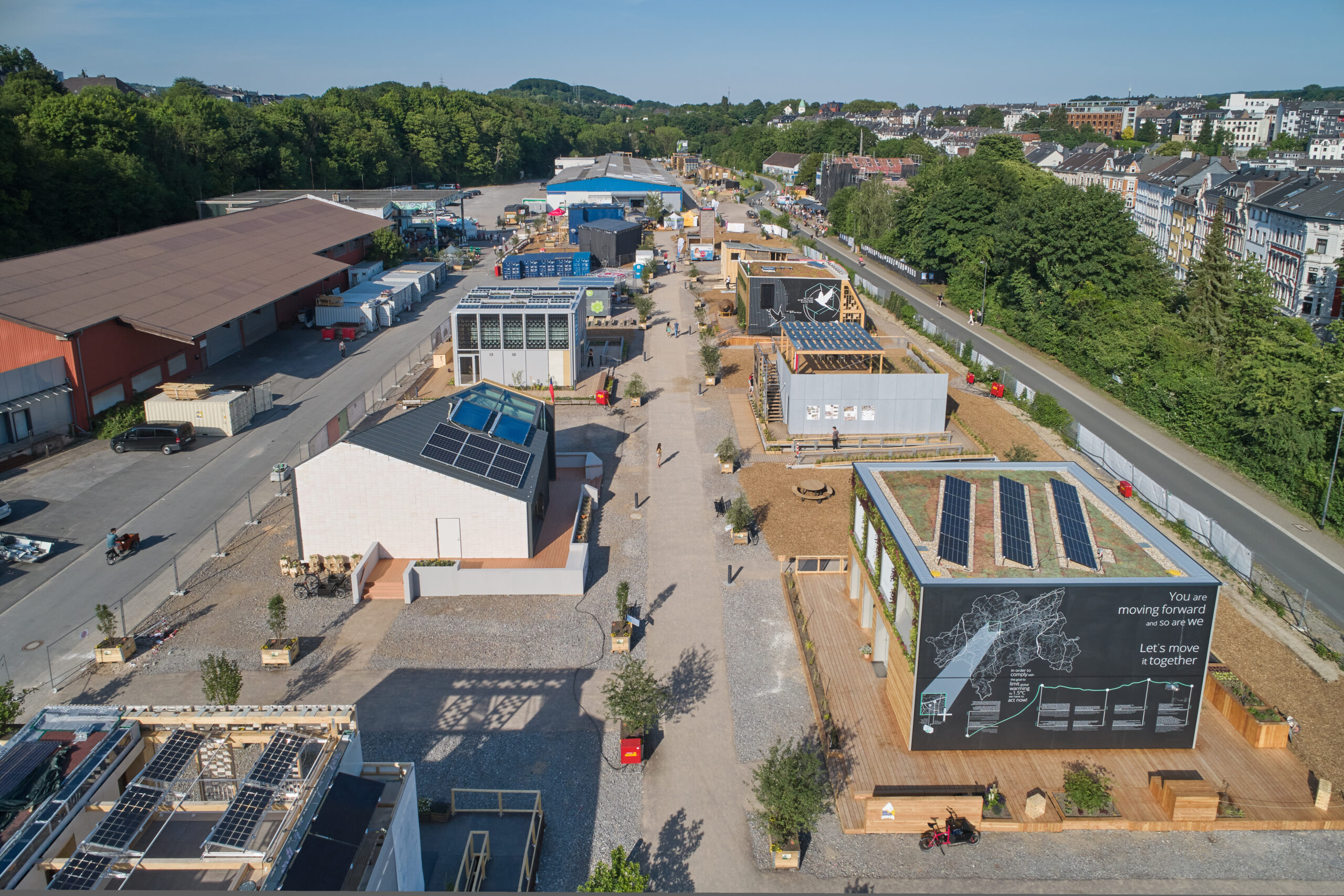 Aerial view of Living Lab NRW, featuring several buildings and solar panels along the Nordbahntrasse in Wuppertal.