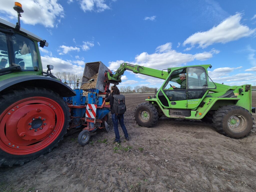 Modern Agriculture: Two large farm machines harvesting crops in a field.